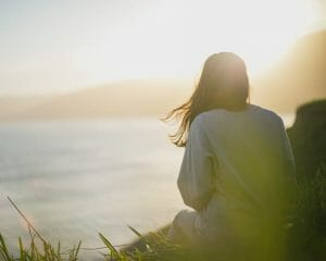 Mulher a olhar para o pôr do sol