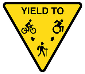 respect other users three user yield sign: cyclists yield to hikers, and hikers yield to assisted device users